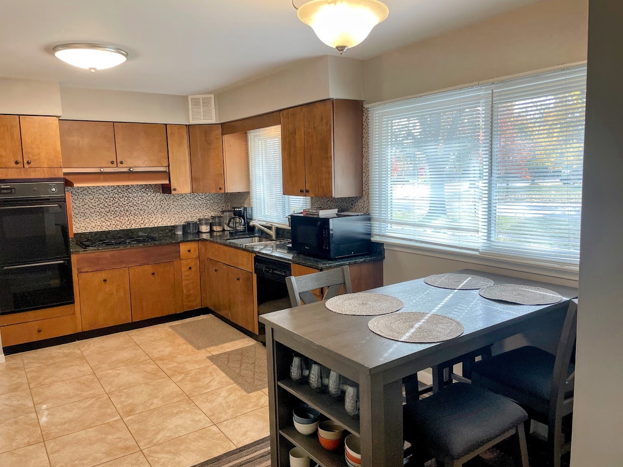 543 South 7th Street West Dundee, IL 60118 - Photo 2 of 12 a kitchen with a table chairs sink and cabinets
