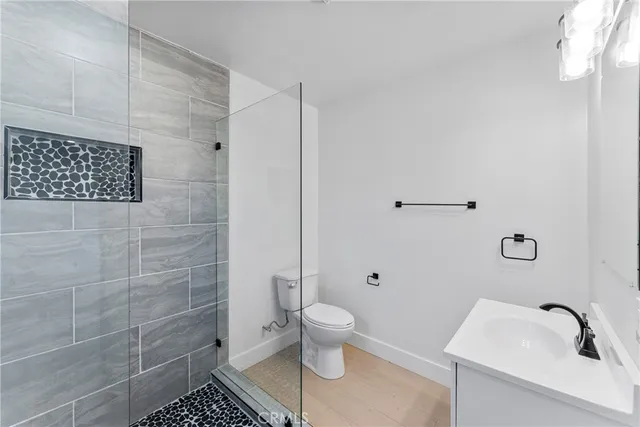 a bathroom with a toilet and a shower