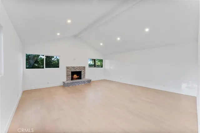 a view of an empty room with a fireplace