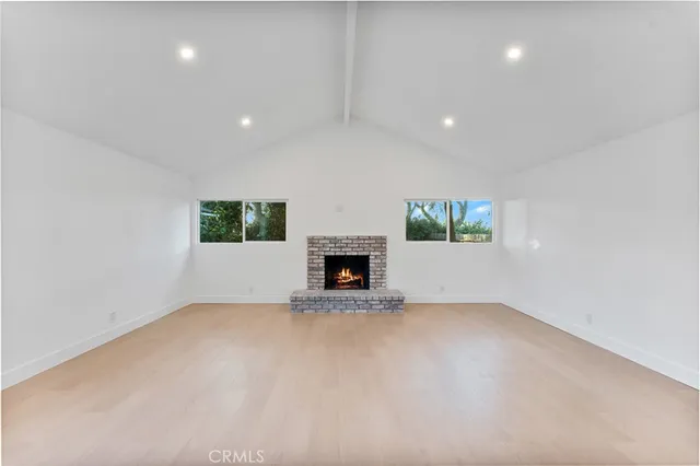 a view of a house with a yard and large tree
