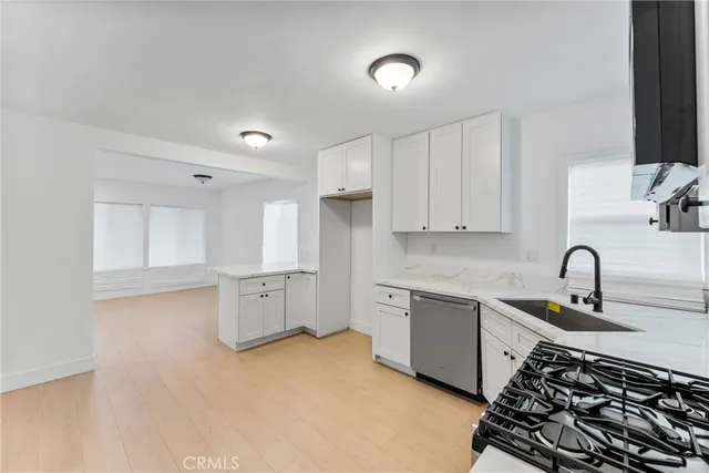 a kitchen with a sink stove and cabinets