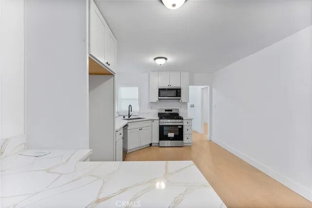 a kitchen with stainless steel appliances a refrigerator and a stove