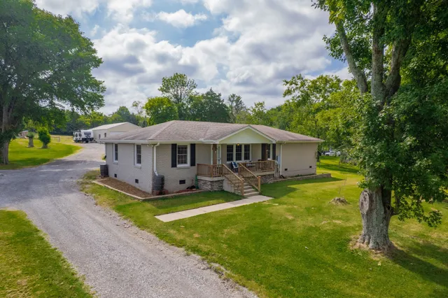 an aerial view of a house with swimming pool and garden