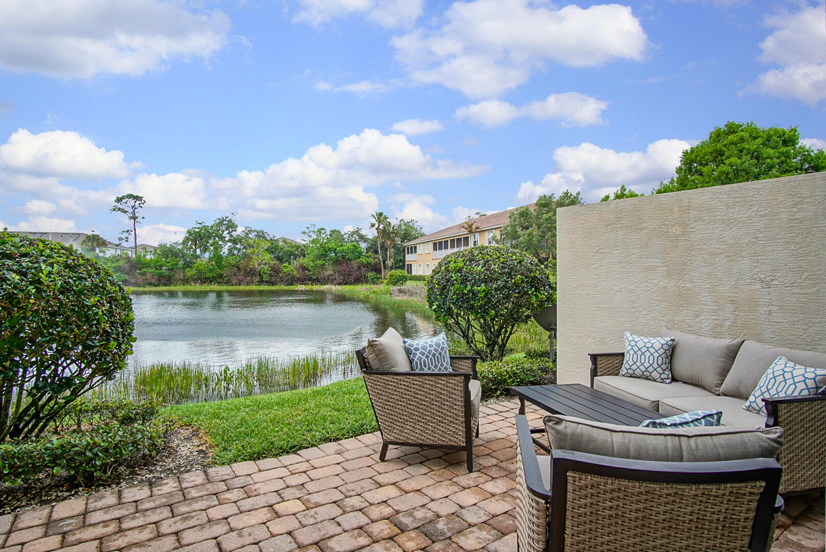 638 Southwest Glen Crest Way Stuart, FL 34997 - Photo 14 of 32 a view of a patio with couches and a table and chairs with wooden fence