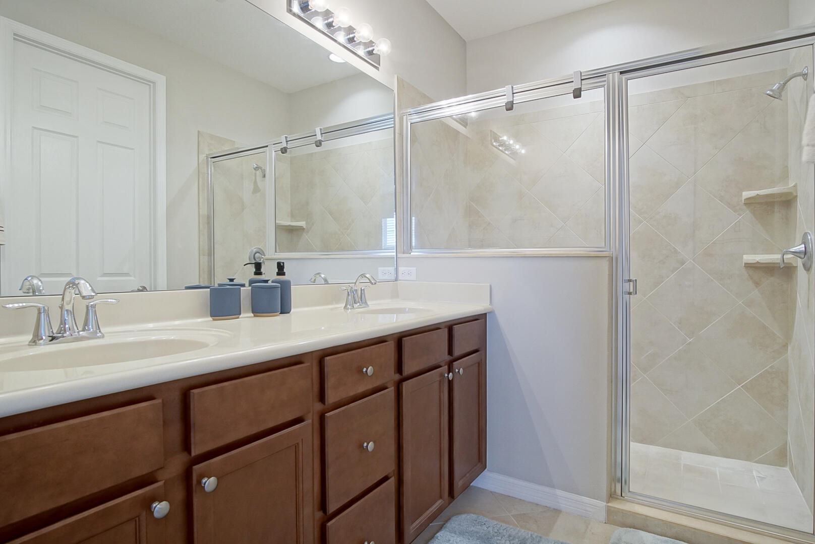 638 Southwest Glen Crest Way Stuart, FL 34997 - Photo 18 of 32 a bathroom with a double vanity sink mirror and shower