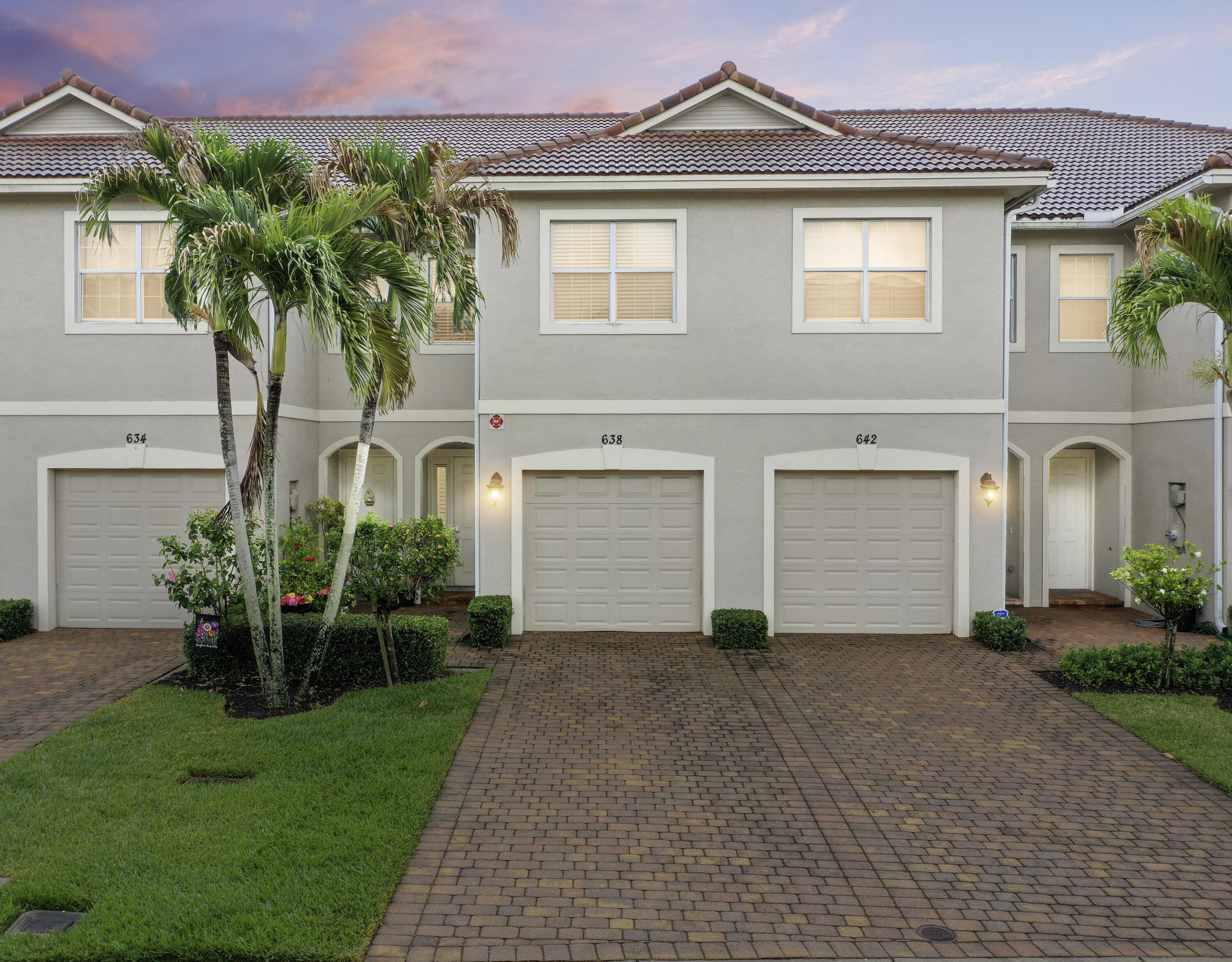 638 Southwest Glen Crest Way Stuart, FL 34997 - Photo 2 of 32 front view of a house with a yard and a garage