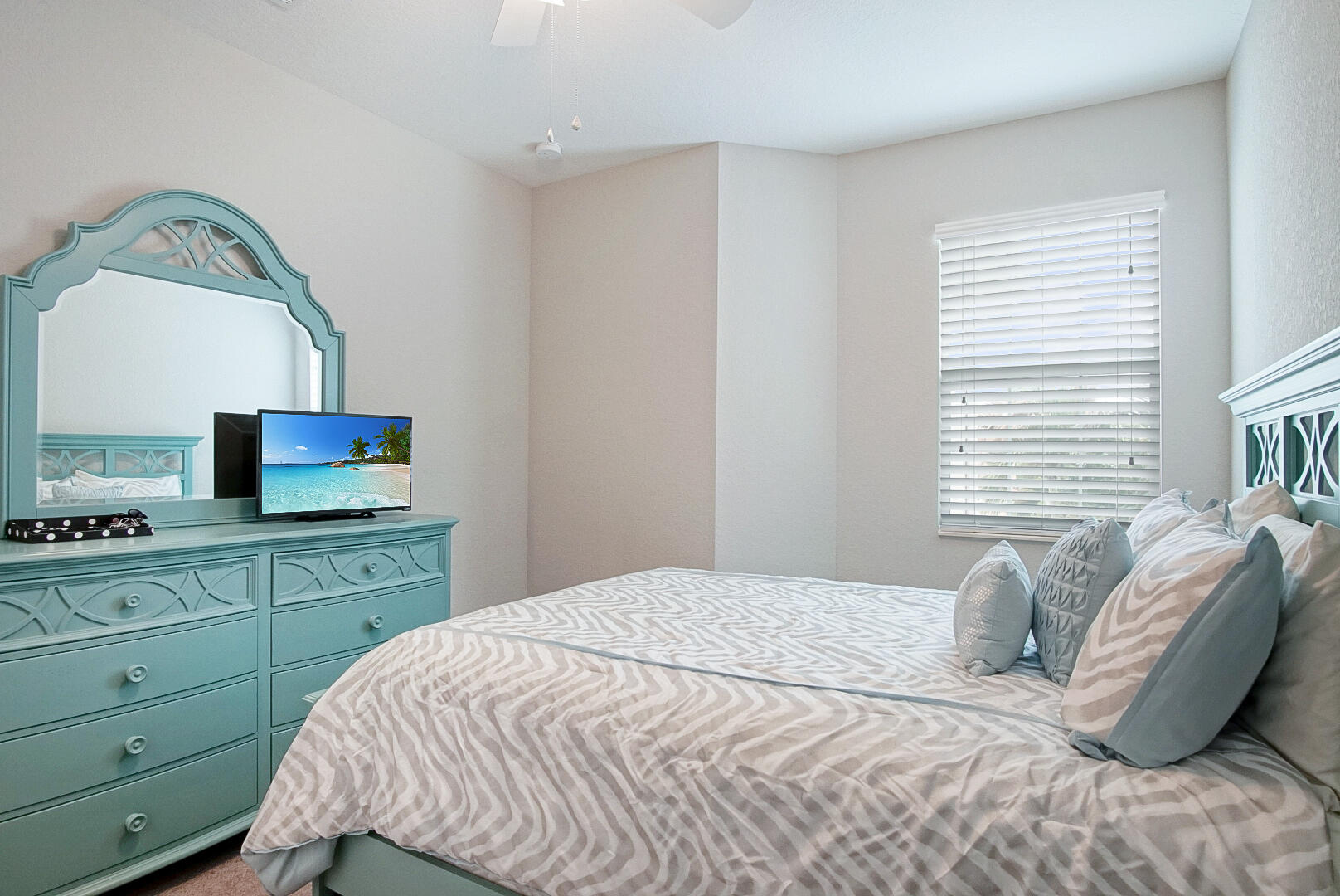 638 Southwest Glen Crest Way Stuart, FL 34997 - Photo 22 of 32 a bedroom with a bed and a television