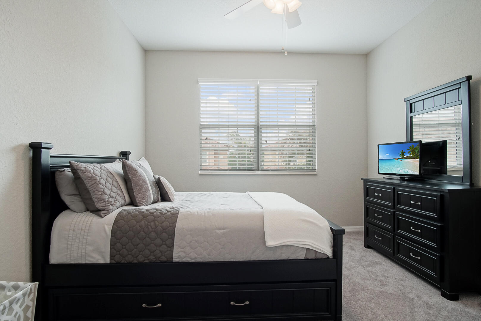 638 Southwest Glen Crest Way Stuart, FL 34997 - Photo 24 of 32 a bedroom with a bed and flat screen tv