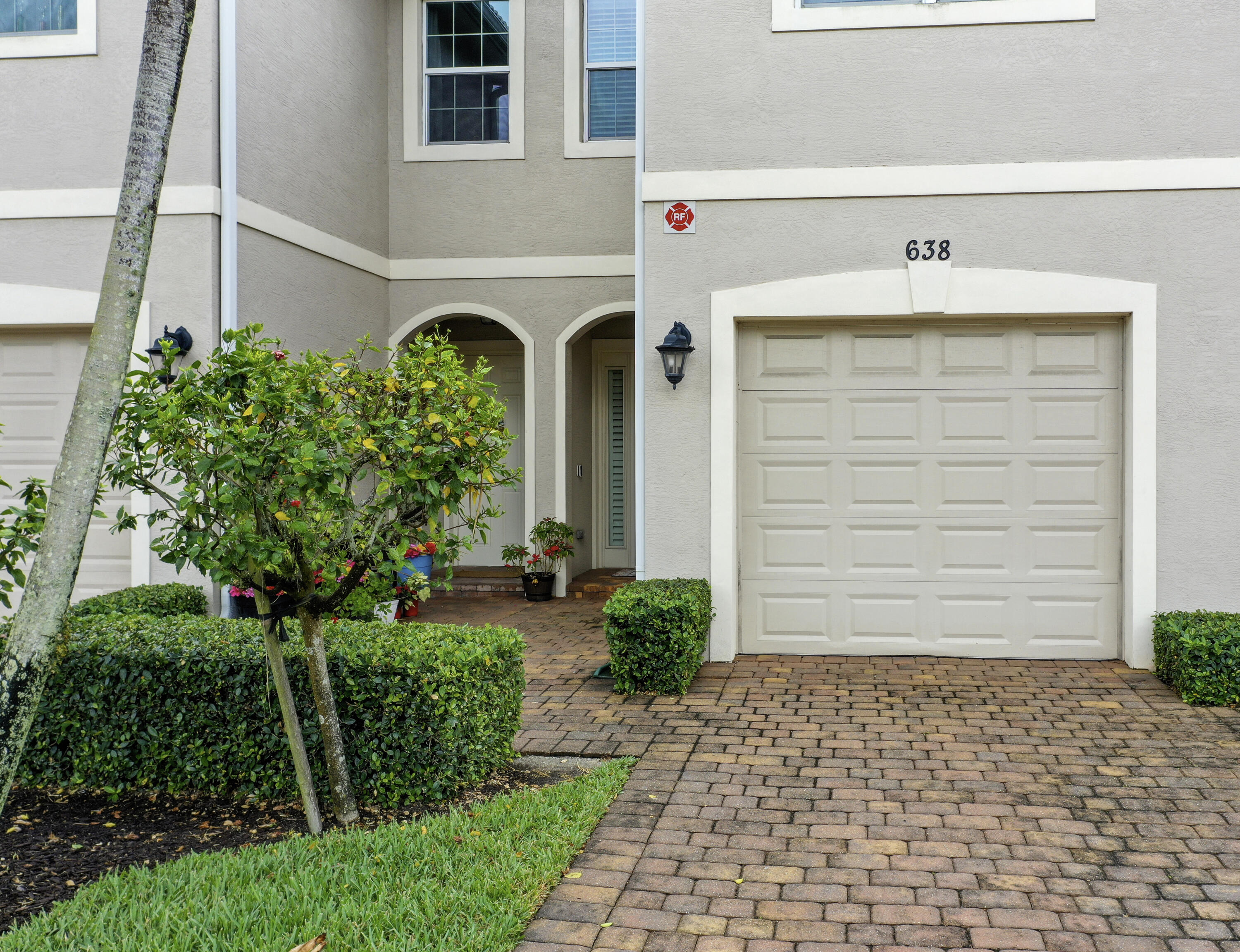 638 Southwest Glen Crest Way Stuart, FL 34997 - Photo 25 of 32 a front view of a house with garden
