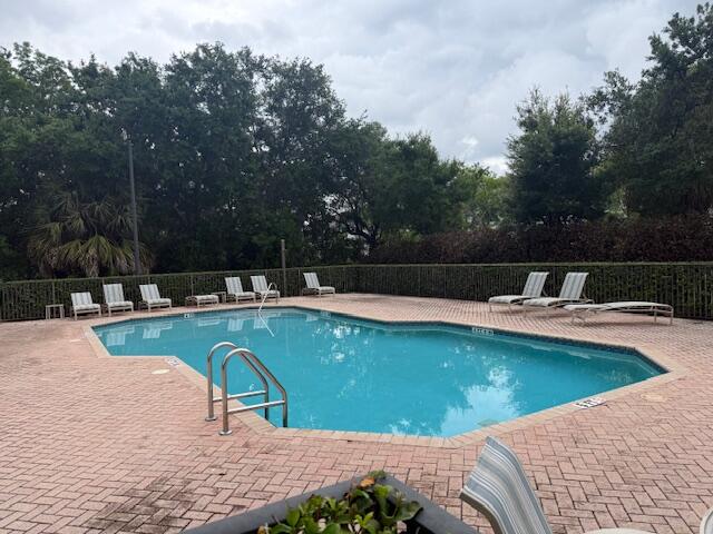 638 Southwest Glen Crest Way Stuart, FL 34997 - Photo 31 of 32 a view of a swimming pool with a lounge chair