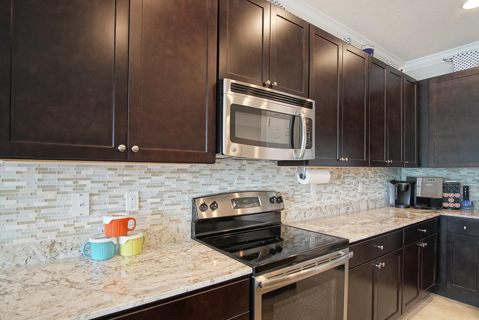 638 Southwest Glen Crest Way Stuart, FL 34997 - Photo 8 of 32 a kitchen with stainless steel appliances wooden cabinets and a sink