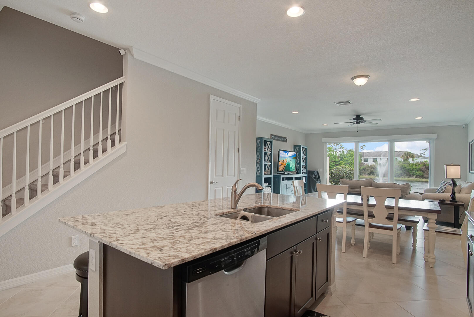 638 Southwest Glen Crest Way Stuart, FL 34997 - Photo 9 of 32 a kitchen with sink table and chairs