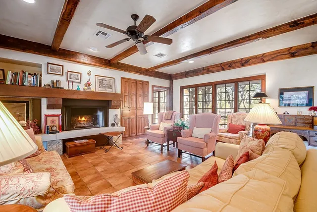 a living room with furniture ceiling fan and a fireplace
