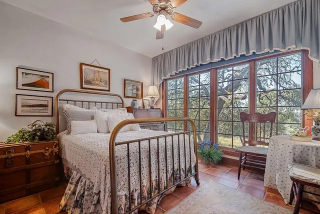 a bedroom with furniture and a large window