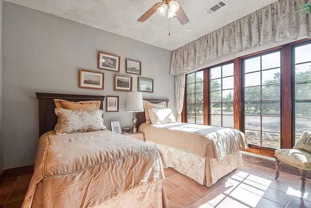 a bedroom with a large bed and a large window