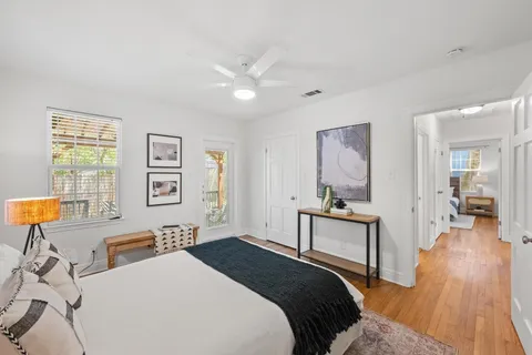 a bedroom with a bed and wooden floor