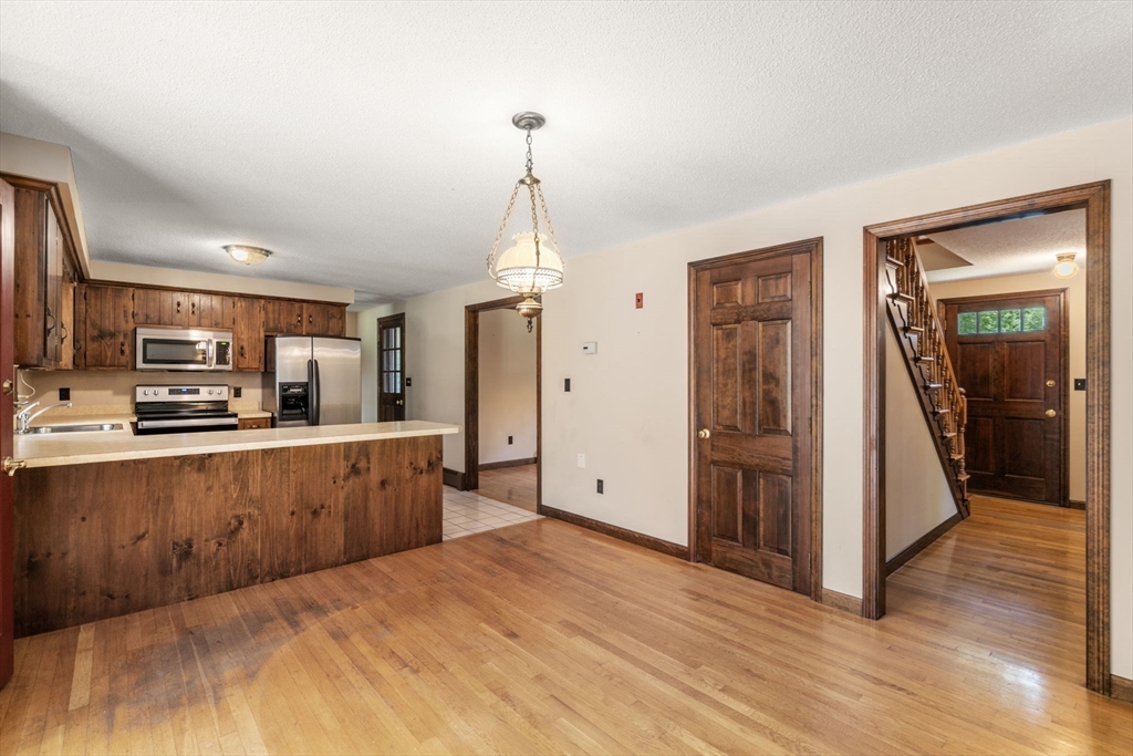 9 Randall Road Rochester, MA 02770 - Photo 11 of 42 a large kitchen with stainless steel appliances kitchen island granite countertop a refrigerator and a stove top oven