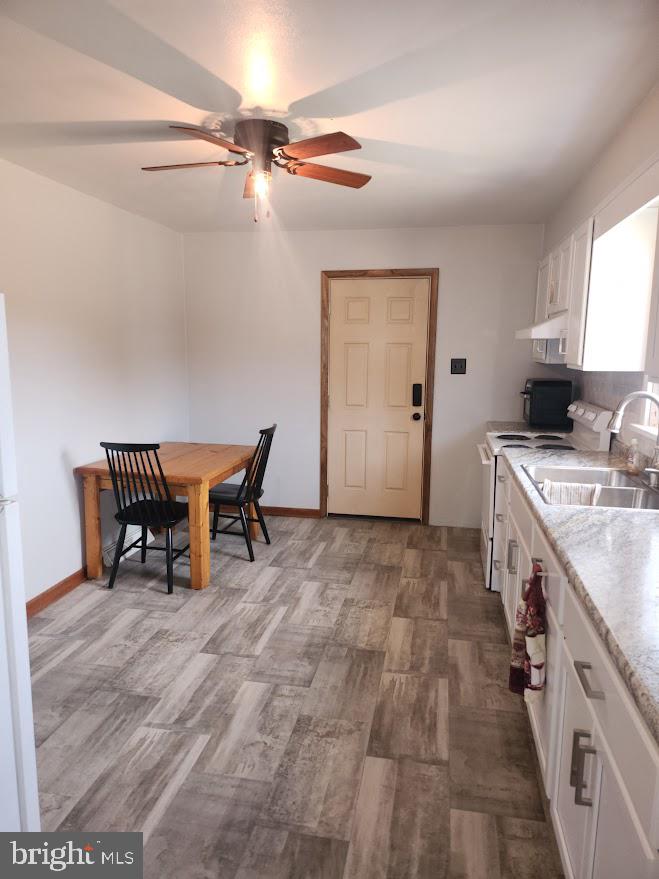 10314 Hyndman Road Manns Choice, PA 15550 - Photo 11 of 54 a kitchen with a sink cabinets and wooden floor