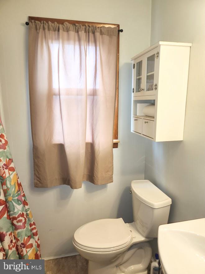 10314 Hyndman Road Manns Choice, PA 15550 - Photo 19 of 54 a white toilet sitting next to a bathroom sink and a tub