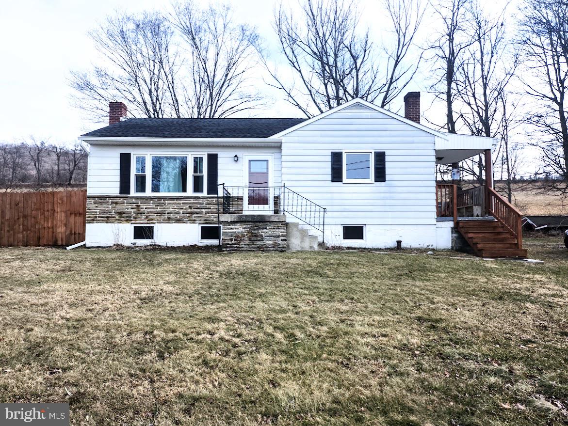 10314 Hyndman Road Manns Choice, PA 15550 - Photo 2 of 54 a front view of a house with a yard