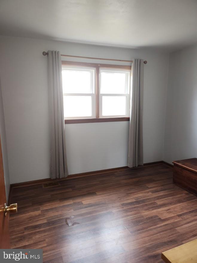 10314 Hyndman Road Manns Choice, PA 15550 - Photo 24 of 54 an empty room with wooden floor and windows