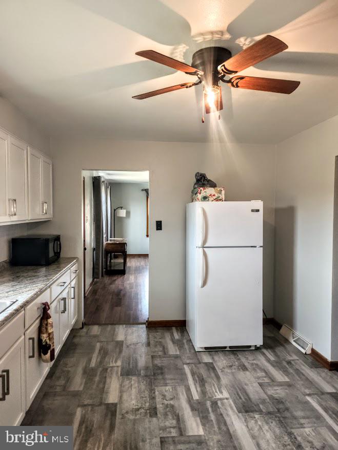 10314 Hyndman Road Manns Choice, PA 15550 - Photo 7 of 54 a kitchen with a stove a refrigerator and cabinets