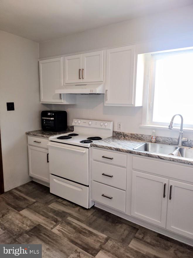 10314 Hyndman Road Manns Choice, PA 15550 - Photo 9 of 54 a kitchen with granite countertop white cabinets and white appliances