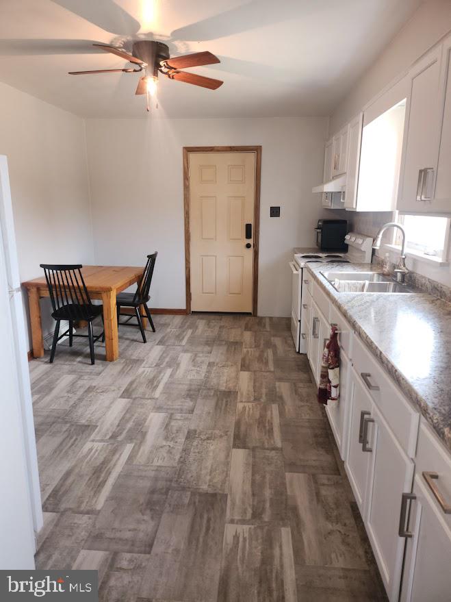 10314 Hyndman Road Manns Choice, PA 15550 - Photo 10 of 54 a kitchen with a sink and chairs