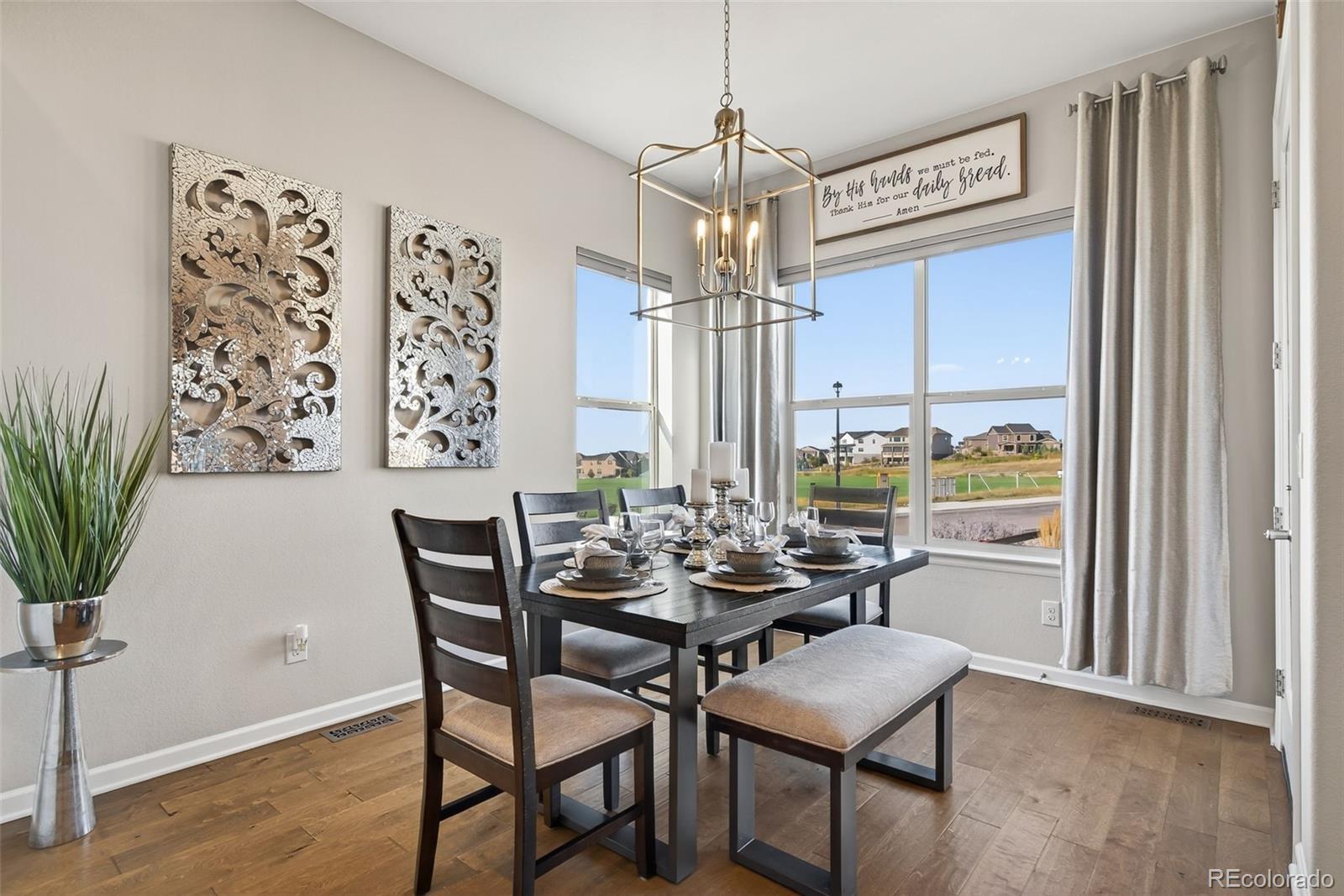 14094 Ivy Court Thornton, CO 80602 - Photo 11 of 44 a view of a dining room with furniture window and wooden floor