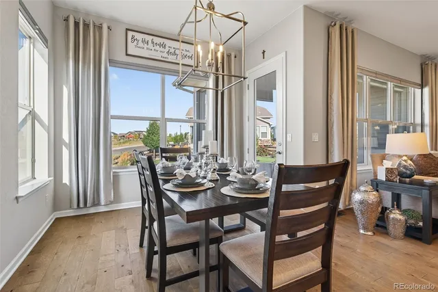 a view of a dining room with furniture wooden floor and a chandelier