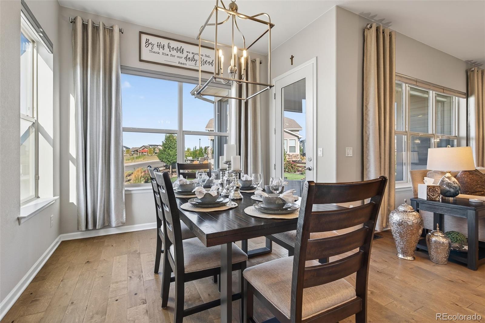 14094 Ivy Court Thornton, CO 80602 - Photo 12 of 44 a view of a dining room with furniture wooden floor and a chandelier