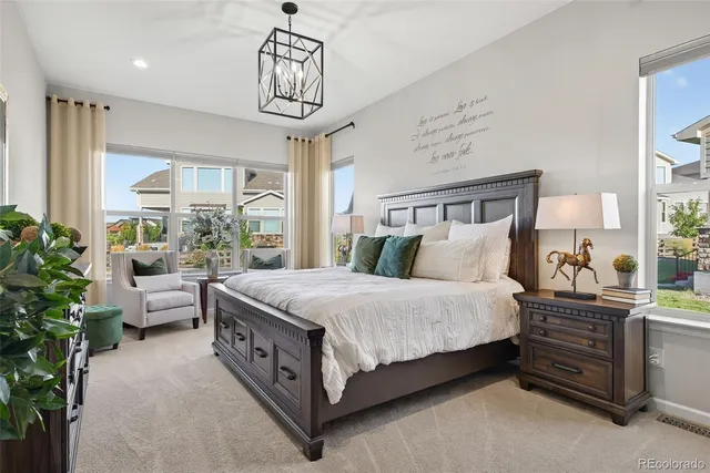 a bed room with a bed and a chandelier