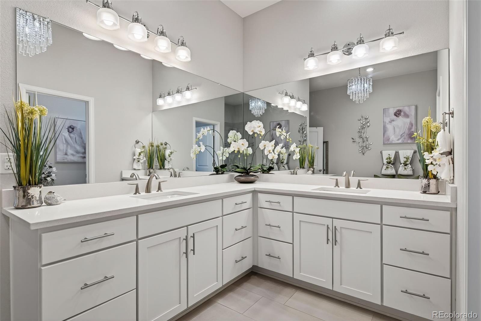 14094 Ivy Court Thornton, CO 80602 - Photo 15 of 44 a spacious bathroom with double sink a large mirror a light fixtures and yellow