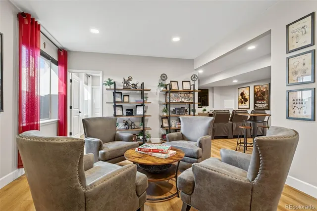 a living room with furniture kitchen and a large window