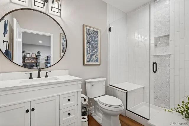 a bathroom with a sink a toilet and a mirror