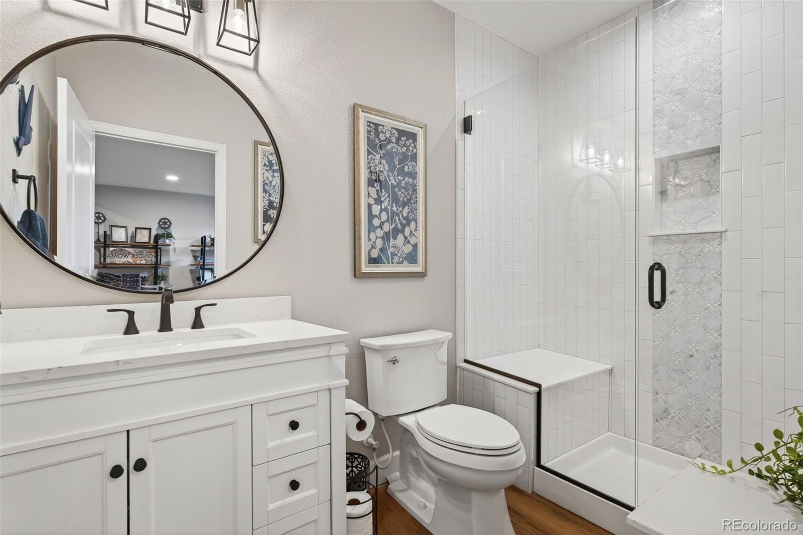14094 Ivy Court Thornton, CO 80602 - Photo 24 of 44 a bathroom with a sink a toilet and a mirror