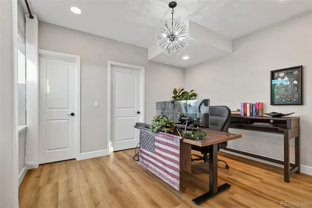 a view of a workspace with furniture and wooden floor