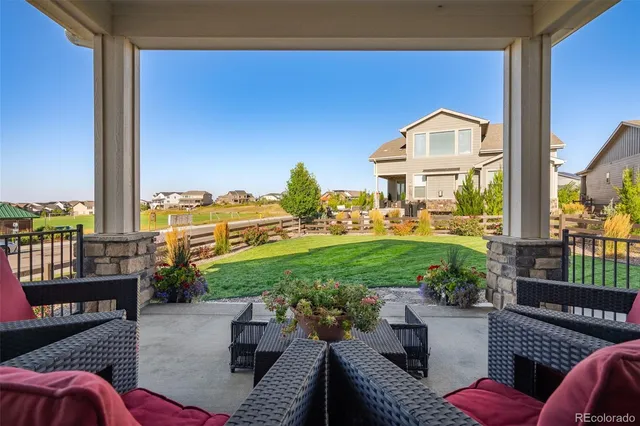 a view of a patio with couches chairs potted plants and a table