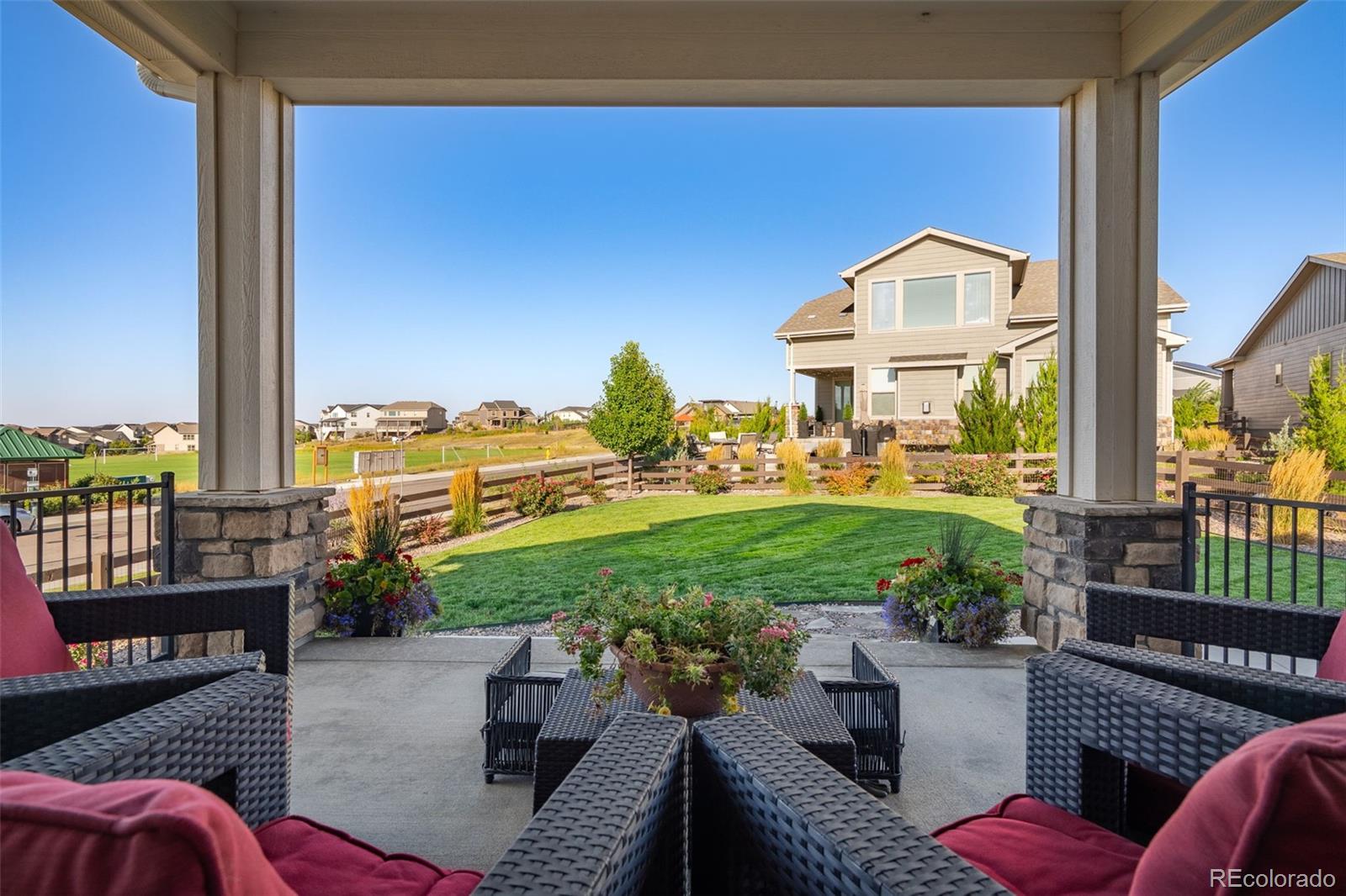 14094 Ivy Court Thornton, CO 80602 - Photo 27 of 44 a view of a patio with couches chairs potted plants and a table