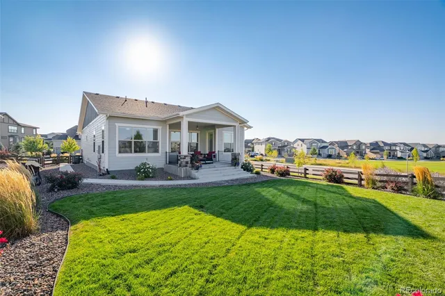 a view of a house with a big yard and potted plants