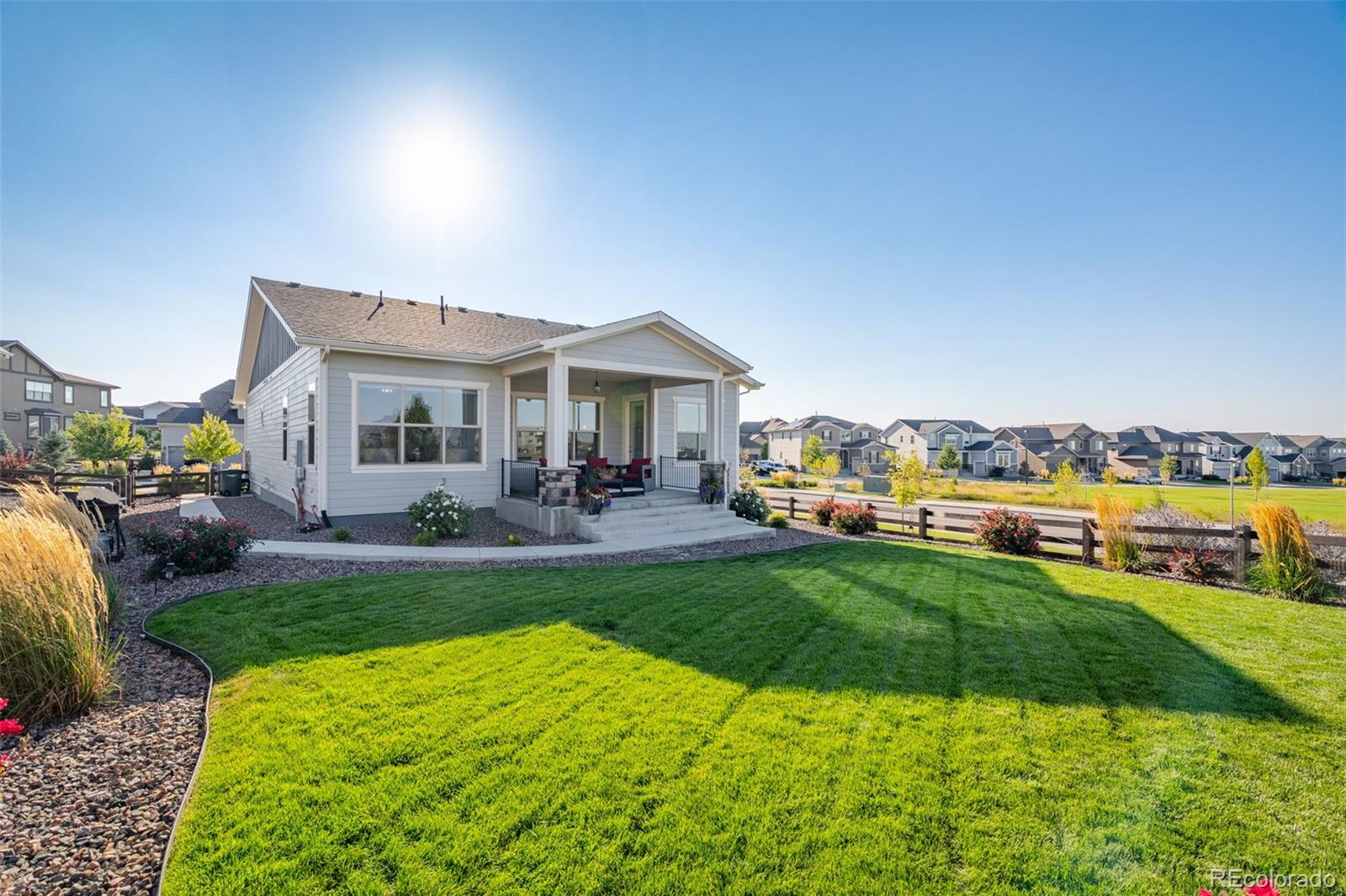 14094 Ivy Court Thornton, CO 80602 - Photo 29 of 44 a view of a house with a big yard and potted plants