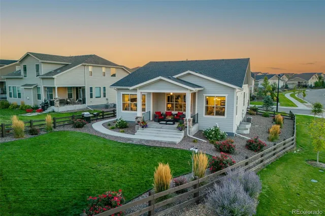 a front view of house with yard and outdoor seating