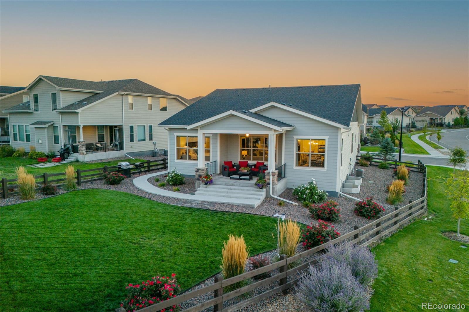 14094 Ivy Court Thornton, CO 80602 - Photo 32 of 44 a front view of house with yard and outdoor seating