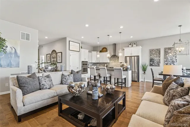 a living room with furniture kitchen view and a table