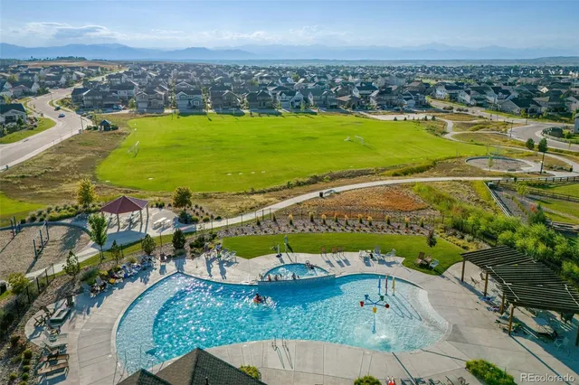 an aerial view of a swimming pool with a yard