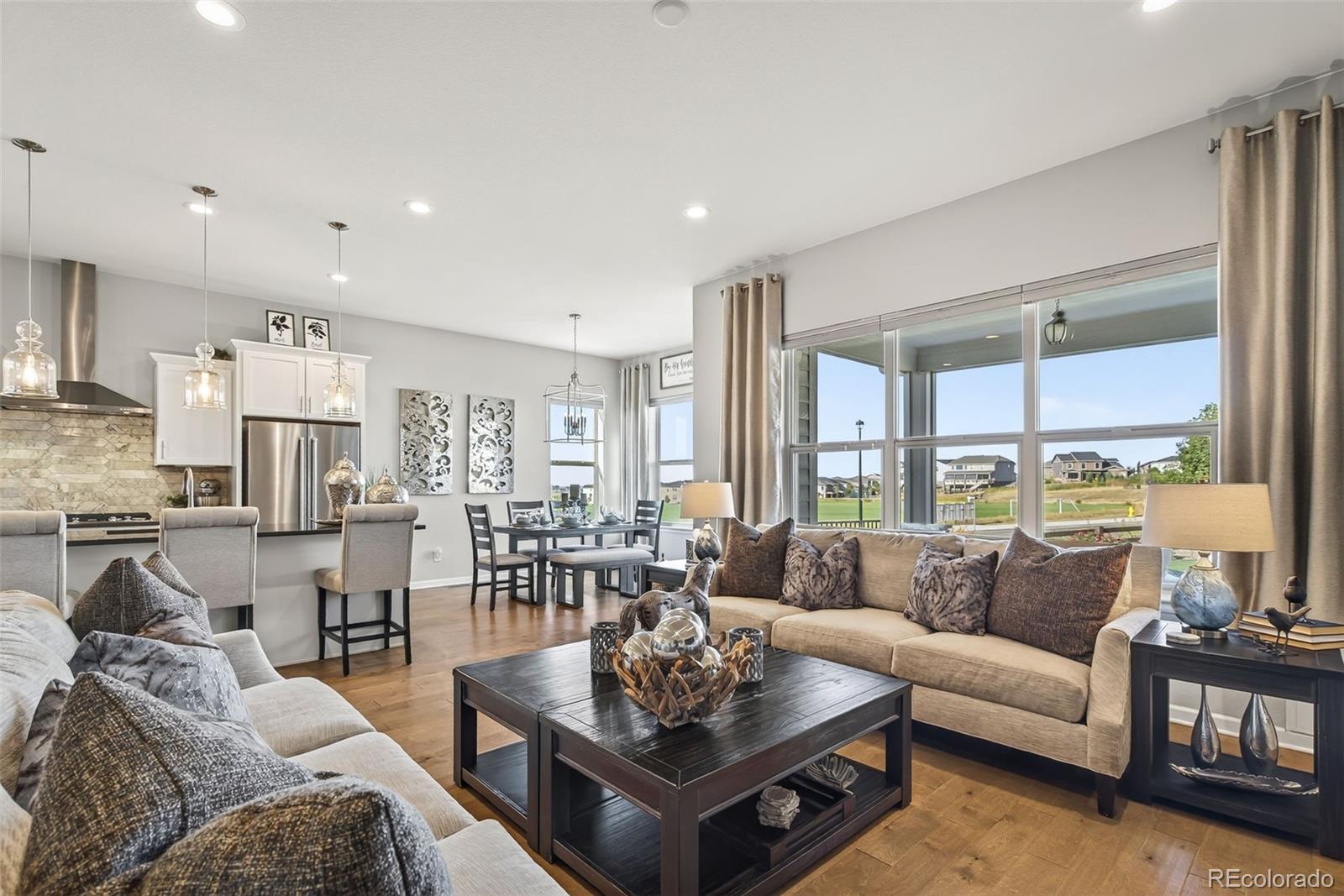 14094 Ivy Court Thornton, CO 80602 - Photo 10 of 44 a living room with furniture wooden floor and a large window