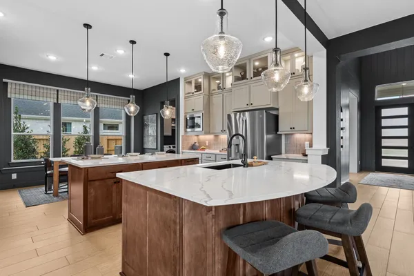 a large kitchen with a table and chairs