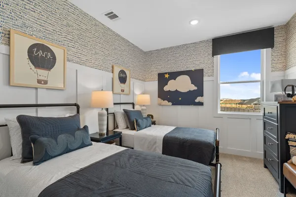 a bedroom with furniture and a dresser