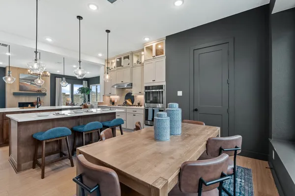 a large kitchen with a table and chairs