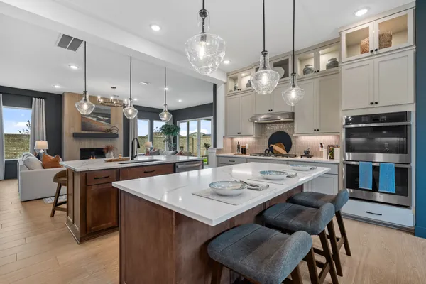 a kitchen with cabinets a center island and stainless steel appliances